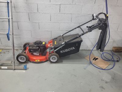 a picture of a lawn mower parked in a garage