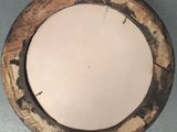 a round mirror that is sitting on a table