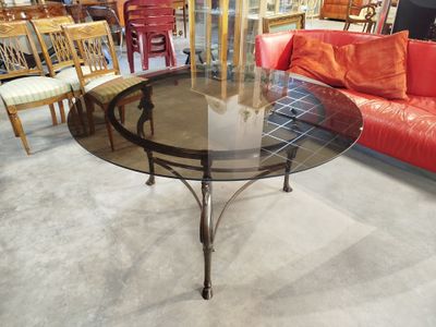 a table with a glass top and chairs in a room