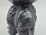 an image of a sculpture of a bear with a bowl on its head