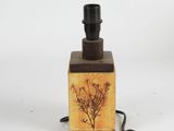 a small lamp that has a wooden box with a plant on it