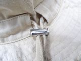 a close up of a button on a white jacket