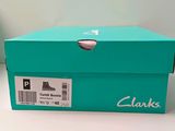 a blue box with a pair of shoes in it