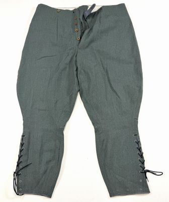 a pair of green pants with laces on the legs