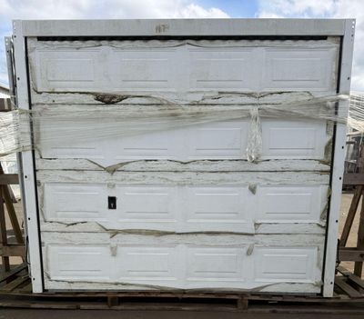 a large white refrigerator sitting on top of a wooden pallet