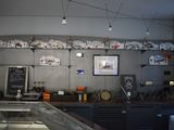 a counter in a restaurant with a lot of items on the shelves