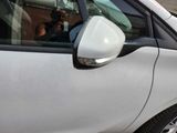 a man sitting in a car with a cell phone in his hand