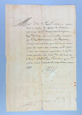 a piece of paper with handwriting on it sitting on top of a table