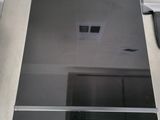 someone is taking a picture of a stove top with their reflection in the glass