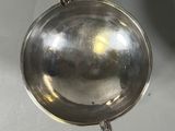 a silver pan hanging from a hook on the wall