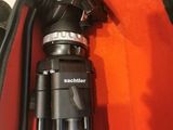 a camera and tripod in a bag on the floor