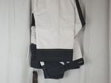 a pair of white pants hanging on a wall next to a white curtain