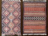two rugs of different colors and patterns on a brown surface