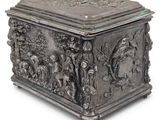 a silver box with a design of people and animals on it