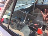 a reflection of a person in the rear window of a car