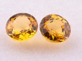 a pair of yellow sapphires on a white surface