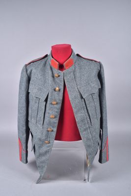 an image of a grey jacket with red trims on a mannequin stand