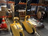 two yellow pedals that are sitting in a warehouse