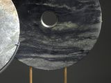 two pieces of art that are sitting on a stand