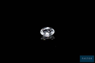 a white diamond on a black surface with a reflection