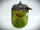 a glass jar with a lid that has a bird on it