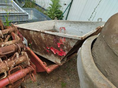 a rusty wheelbarrow and a rusty wheelbarrow in a yard