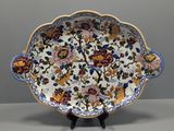 a close up of a plate with flowers on it on a stand