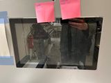 a person taking a picture of a microwave with post - it notes on it