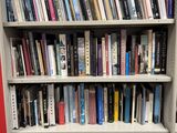 a book shelf with many books on it in a library
