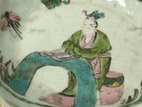 a picture of a bowl with a woman sitting on it