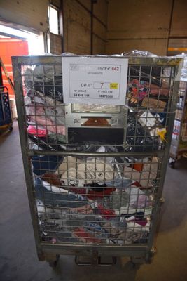 a metal cage with a sign on top of it in a warehouse