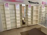 many shelves in a store with glass shelves on them
