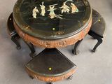 a table with three stools and a table with a painting on it