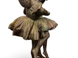 bronze statue of a girl in a tutu with a bird on her head