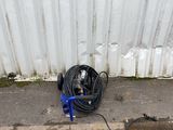 a hose on the ground next to a wall