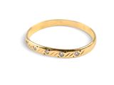 a close up of a gold ring on a white background