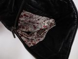 a black leather jacket with a floral print lining