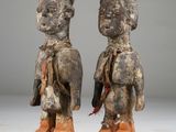 pair of carved wooden figures of a man and a woman