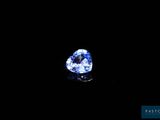 a heart shaped blue sapphire on a black background