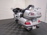 a silver motorcycle parked in a room with a checkered floor