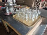 many empty glasses sitting on a table with a tray on it