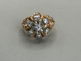 a close up of a gold and diamond ring on a white surface