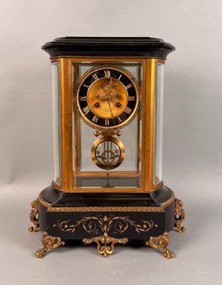 a black and gold clock on a white background
