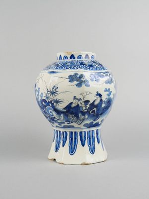 blue and white vase with a bird and flowers design on the lid