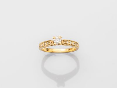 a yellow gold ring with a single diamond