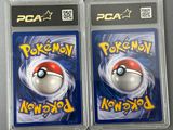 two packs of pokemon cards in plastic cases on a table