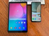 the two phones are sitting next to each other on the table