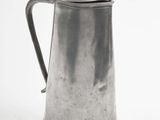 a silver pitcher with a handle on a white background