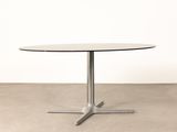 a round table with a metal base and a glass top