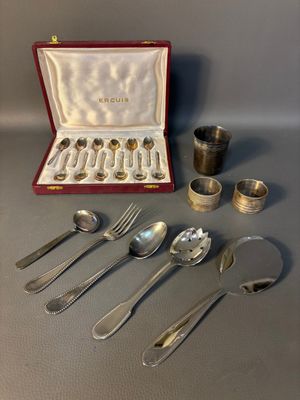 a lot of silver spoons and spoons in a case